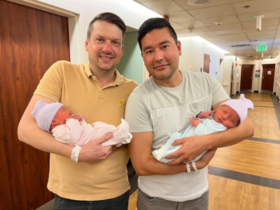 Image of Chris (left) and Bryan (right) in the hospital together shortly after their twins, Brecon and London, are born.